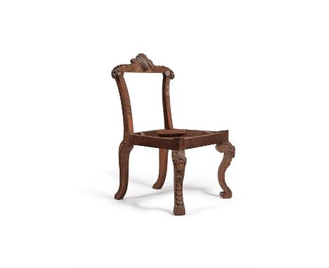 A carved ash side chair, after a design by William Kent, elements possibly 18th century, the foliate scroll moulded top rail 
