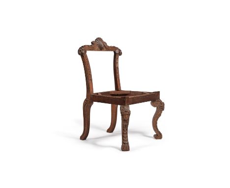 A carved ash side chair, after a design by William Kent, elements possibly 18th century, the foliate scroll moulded top rail 