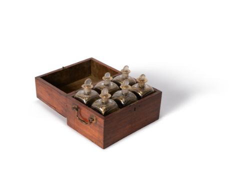 A late George III mahogany and metal mounted six-bottle decanter case, late 18th/early 19th century, of hinged rectangular fo