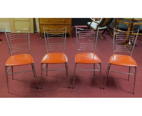 Four vintage 1960's French dining chairs, with orange vinyl seats on tapered legs 