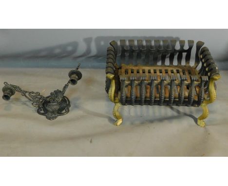 A twin sconce metal wall light and an iron fire grate on cabriole supports. H.24 W.41 D.32cm 