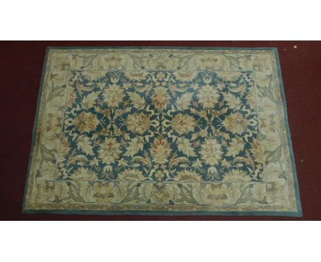 A large woollen floral design carpet. 245x168cm (wear to one edge) 