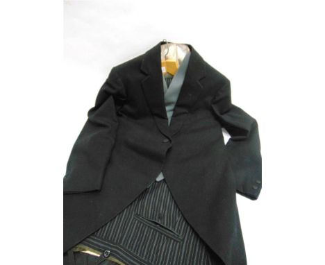A GENT'S MORNING SUIT comprising black tail coat, grey waistcoat, grey tie and a pair of black and grey striped trousers