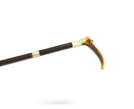 A GENT'S HUNTING WHIP with horn grip, silver collar engraved 'W.E.M. From F.W', another collar with engraved date '1911' & pl