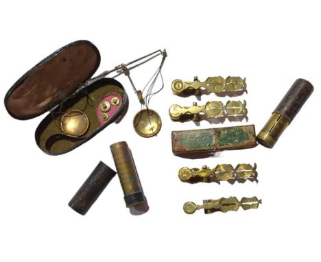 A set of brass sovereign scales in original box; three unboxed sovereign scales; two late 19th/early 20th Century coin tubes 