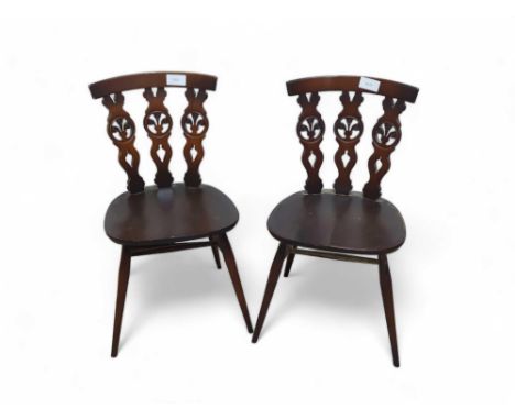 Two Ercol dark elm dining chairs