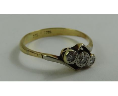 A diamond three stone twist ring, marked '18ct 18c', finger size P 1/2, 2.4g gross