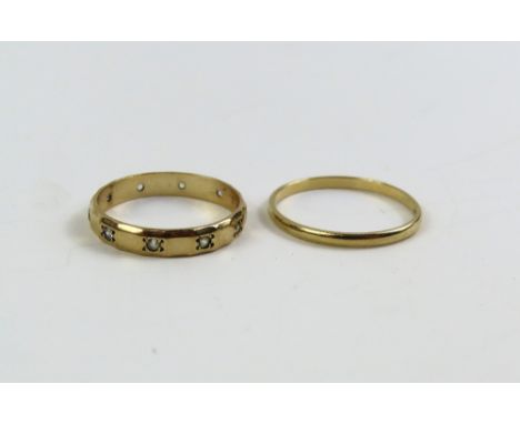 A 9ct gold wedding band, finger size Q 1/2, and a stone set eternity ring marked '9ct', finger size O, 2.7g gross