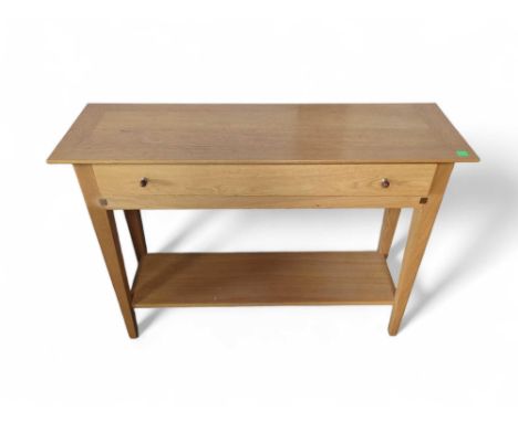 An Ernest Menard light oak console table with single drawer and shelf below 110cm x 35cm x 81cm