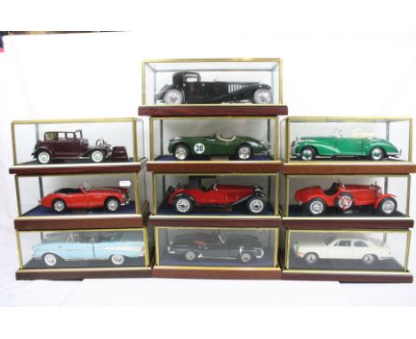 Ten cased 1:18 scale diecast model vintage cars to include Alfa Romeo, Mercedes, Rolls Royce etc, models fixed to wooden plin