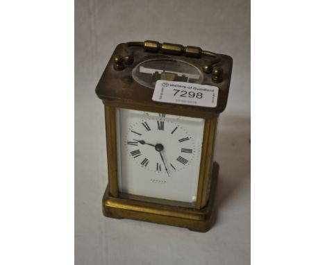 Brass carriage clock, white enamel dial with Roman numerals, signed Comber, 14cm including carrying handle