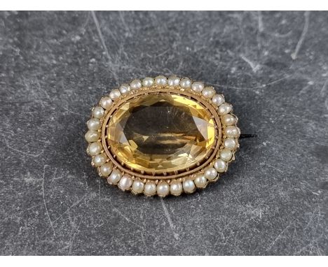 A gold plated citrine and split pearl brooch, 28mm wide, with steel pin.