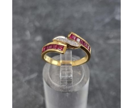 A diamond and ruby crossover ring, set five brilliant cut diamonds to centre with a row of five pave set square rubies to eac