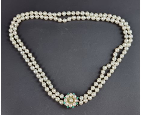 A cultured pearl two strand necklace, the pearls of uniform size and fastened by a 9ct gold circular clasp, set with cultured