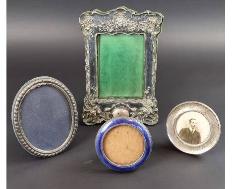 Four silver mounted photograph frames; to include a guilloche enamel inlaid example. (4) 