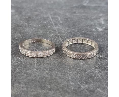 An 18ct white gold diamond ten stone half eternity ring, size J1/2; together with another 18ct white gold eternity ring, size