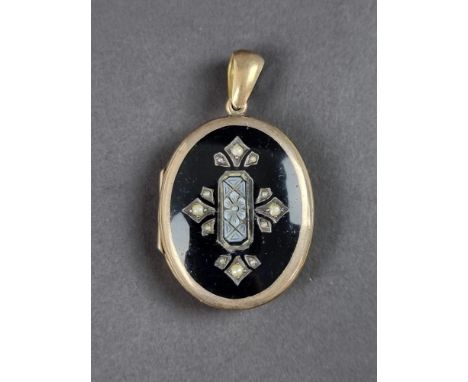 A Victorian pendant locket, having black enamel and pearl decorated front, 38mm high.