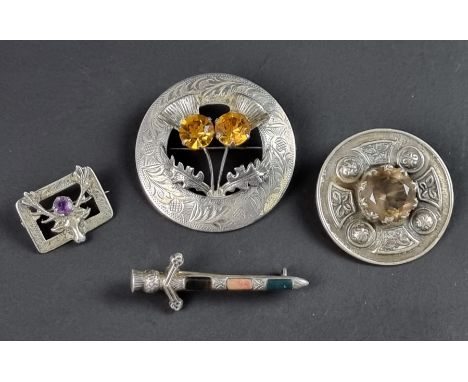 A Scottish Celtic style silver brooch, by Robert Allison, Glasgow 1952; together with two others, by&nbsp;Ward Brothers; and 