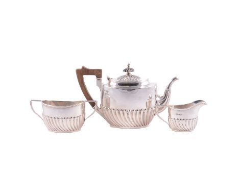 A silver three piece half fluted bachelor teaset, wooden handle and finial, Walker &amp; Hall, Sheffield 1895, 19.3oz.