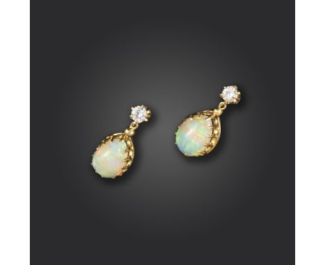 A pair of opal and diamond drop earrings, the round brilliant diamonds suspend pear-shaped opal cabochons in yellow gold, 2cm
