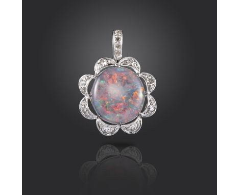 An opal and diamond pendant, the solid black opal cabochon set within scalloped diamond surround in white gold, 2.7cm high