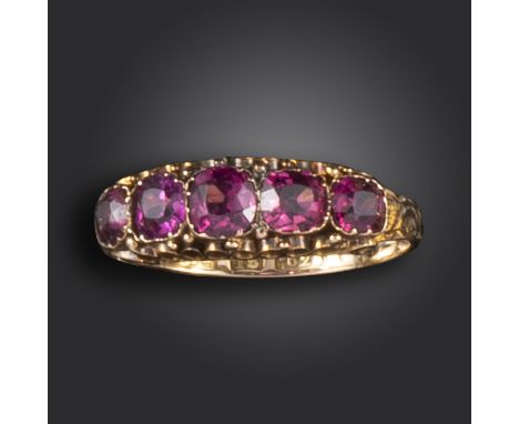 A Victorian garnet five-stone ring, set with cushion-shaped garnets in a gold scrolling mount, engraved decoration to the sha