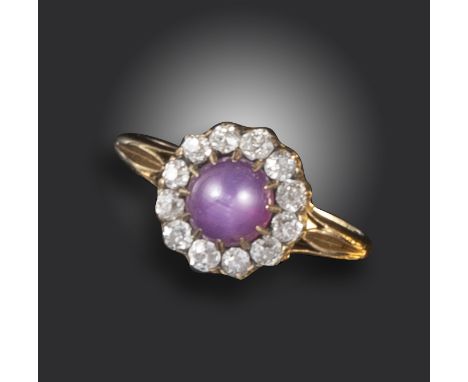 A Victorian star sapphire and diamond cluster ring, the star sapphire cabochon set within a surround of cushion-shaped diamon