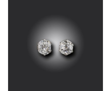 A pair of diamond stud earrings, set with old cushion-shaped diamonds weighing approximately 0.95cts each, in platinum and go