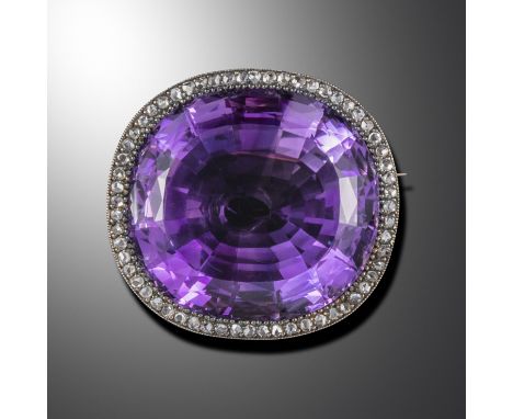 A late Victorian large amethyst and diamond brooch pendant, the cushion-shaped amethyst set within a surround of rose-cut dia