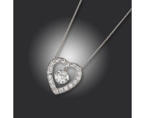 A heart-shaped diamond pendant by J E Caldwell &amp; Co, the heart set with circular-cut diamonds and suspending a larger cir