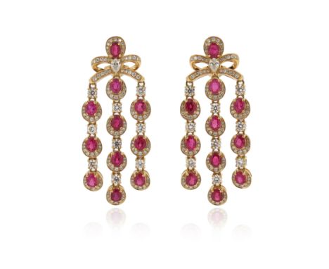 A pair of ruby and diamond-set gold drop earrings, with bow-form upper sections, each suspending three articulated pendants, 