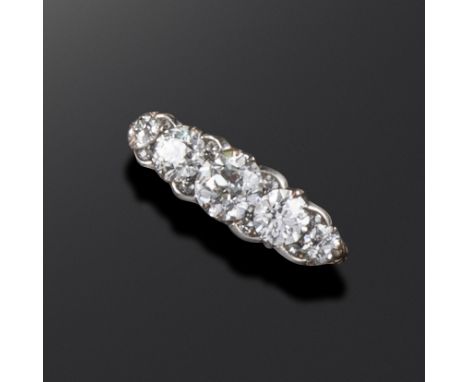 A 19th century diamond five-stone ring, the graduated old circular-cut diamonds set with diamond pointers in carved and pierc