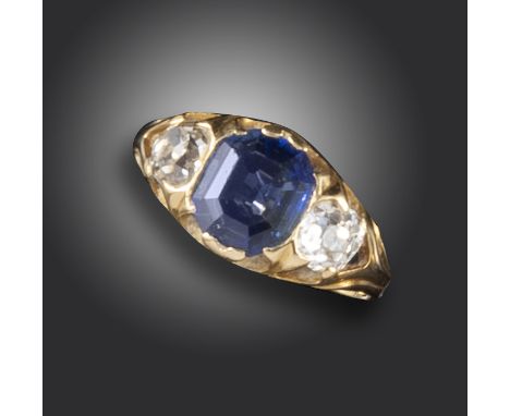 An early 20th century sapphire and diamond three-stone ring, the emerald-cut sapphire flanked with two cushion-shaped diamond