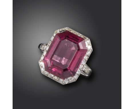 An Art Deco tourmaline and diamond ring, the emerald-cut pink tourmaline set within single-cut diamond border and shoulders i