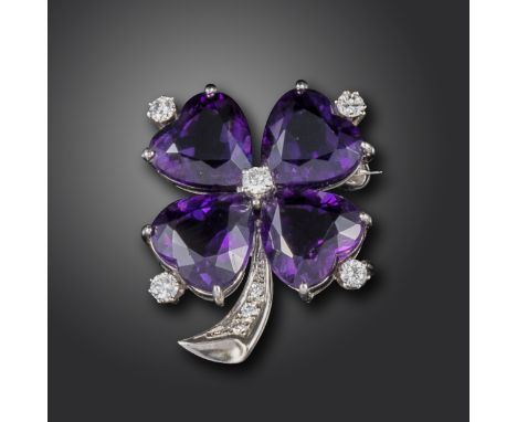 An amethyst and diamond-set shamrock brooch, set with heart-shaped amethysts and circular-cut diamonds in white gold, 3.2cm h