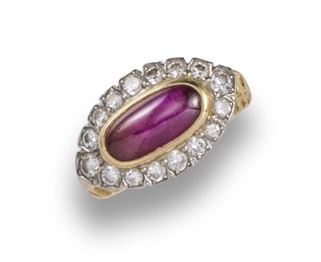 A ruby and diamond ring by Cartier, the oval ruby cabochon set within a surround of diamonds on honeycomb yellow gold band, s