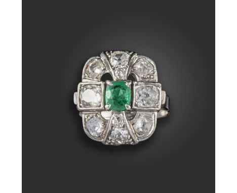 An emerald and diamond ring, of quatrefoil openwork design, set with a cushion-shaped emerald, and further old circular-cut a