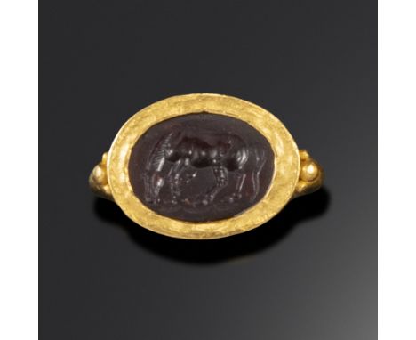 A Roman garnet intaglio depicting a horse, c1st century BC - 1st century AD, the horse grazing and stamping its hoof, in a go