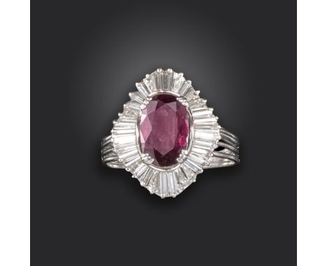 A ruby and diamond cluster ring, centred with an oval-shaped ruby weighing approximately 1.90cts, within ballerina mount set 