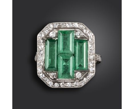 An Art Deco emerald and diamond ring, the four emerald-cut emeralds set within a surround of single-cut diamonds in platinum,