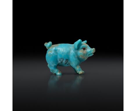 An early 20th century finely carved turquoise miniature pig in the style of Fabergé, carved with hair and a curly tail, looki