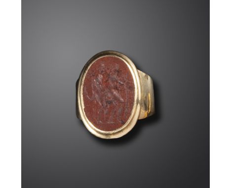 An 18th century erotic jasper intaglio ring, depicting a couple in the midst of a passionate embrace, in yellow gold mount, s