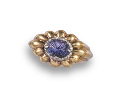 A colour-change sapphire and diamond ring by Boucheron, c1940, the carved colour-change sapphire cabochon set within a surrou