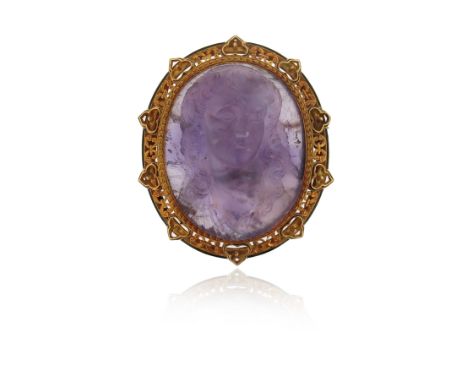 A 19th century carved amethyst cameo brooch, portraying the bust of a woman with flowing hair, ornately scroll pierced gold f