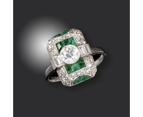 An Art Deco emerald and diamond ring, set with an old circular-cut diamond flanked with baguette-shaped diamonds within emera