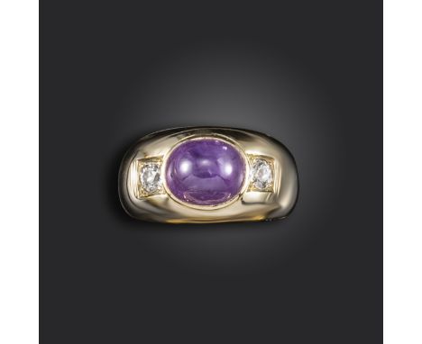 A star sapphire and diamond ring, the sapphire weighs approximately 9.80cts, flanked with old circular-cut diamonds in yellow