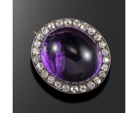 A late Victorian amethyst and diamond brooch, set with an oval amethyst cabochon and a border of old circular-cut diamonds in