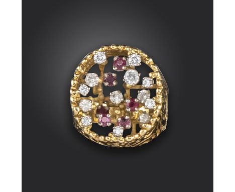 A ruby and diamond dress ring, the pierced cylindrical yellow gold mount set with varying raised circular-cut rubies and diam