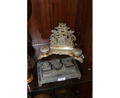 A VINTAGE BRASS DESK STAND WITH INK WELLS TOGETHER WITH ANOTHER