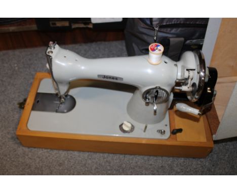 A VINTAGE CASED JONES SEWING MACHINE